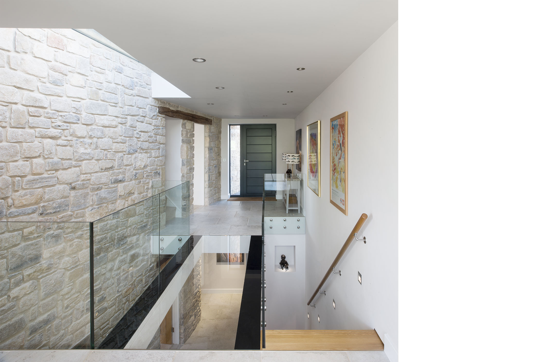 A glass floor adds transparency to the lower floor